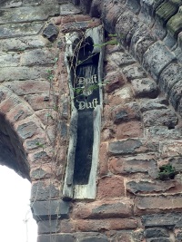 A medieval oak coffin inscribed with the words “Dust to Dust”.